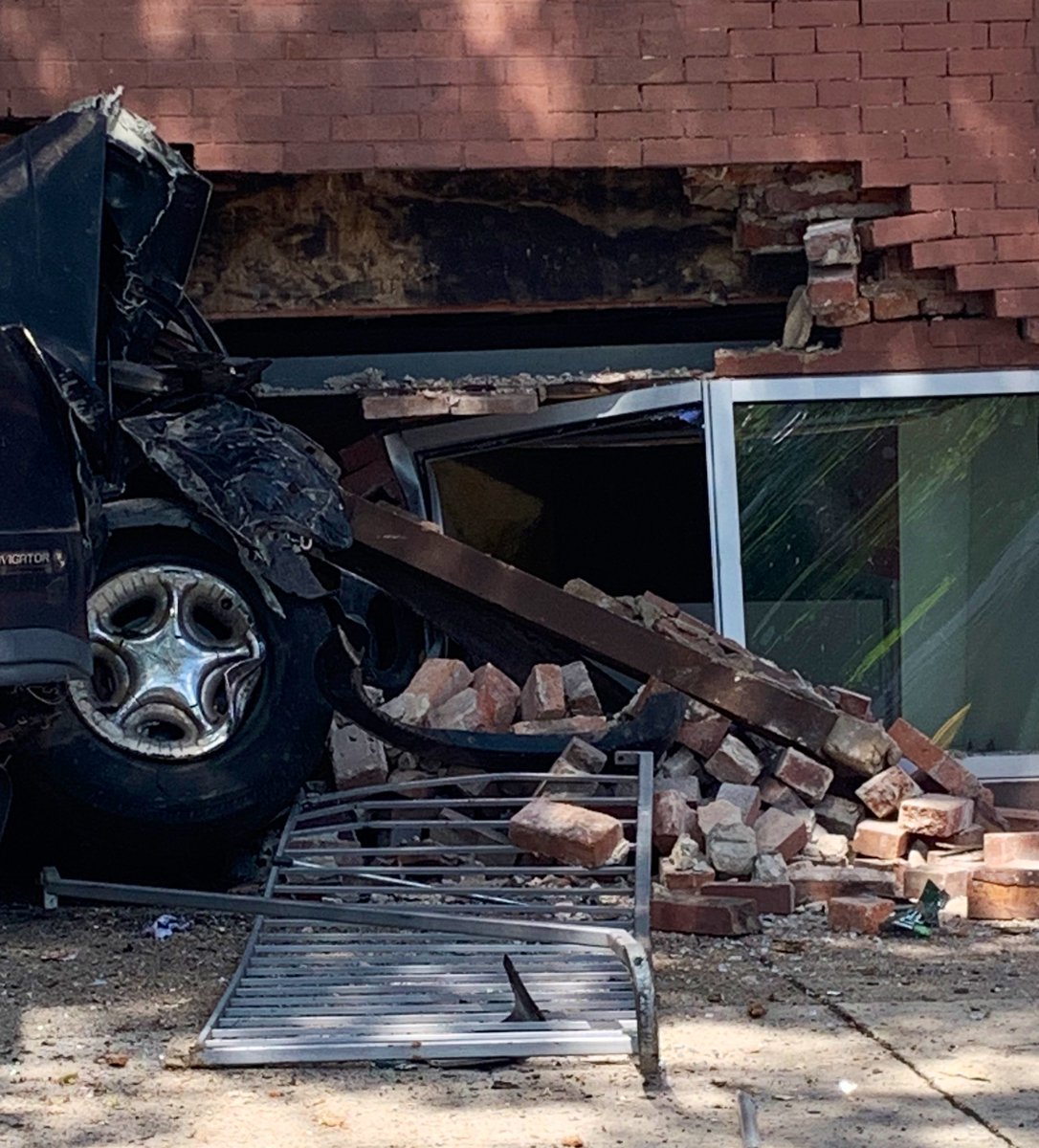 Vehicle into structure 14th St & Meridian Pl. NW. Driver is uninjured and no occupants inside at time of incident. DC firefighters conducting structural assessment, securing utilities, and have established a safety zone