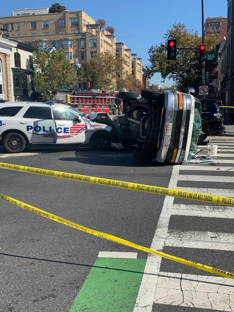 Four-vehicle crash involving a police car and flipped van with 4 injured earlier at 14th and U Street N.W. Onlookers stated that the officer initiated the crash. 