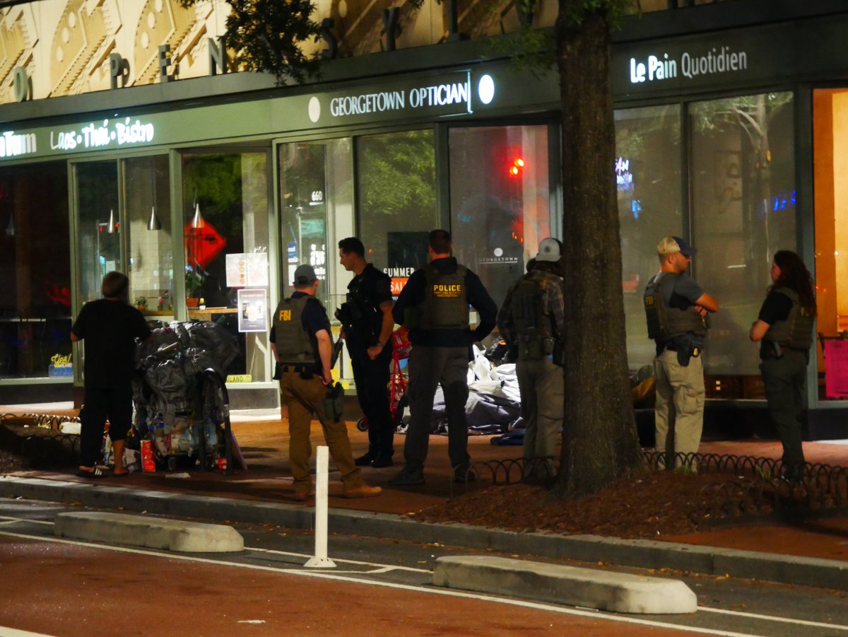 Federal agents & DC Police stop to talk to a few homeless people across from the Eastern Market metro station along Pennsylvania Ave SE in Capitol Hill. (under a directive from the White House)No action was taken by police tonight, only a couple of conversations