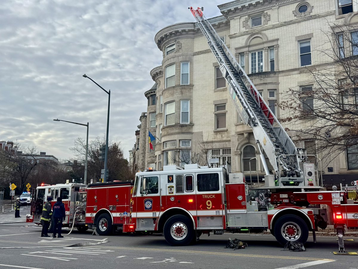 Box Alarm 2100 block S St NW. Hidden fire in attic and roof area of 4 story building. Units opening up and extinguishing fire and checking for extension. No injuries. DC firefighters