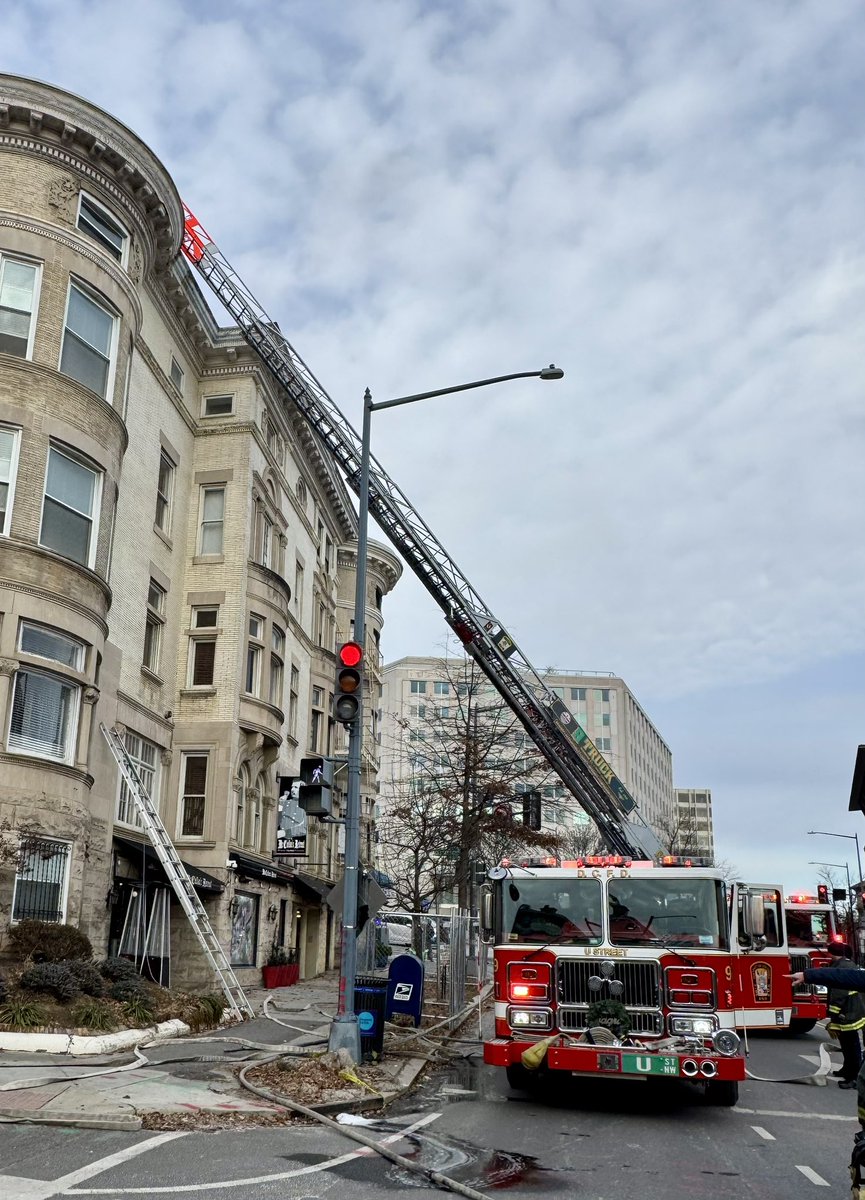 Box Alarm 2100 block S St NW. Hidden fire in attic and roof area of 4 story building. Units opening up and extinguishing fire and checking for extension. No injuries. DC firefighters