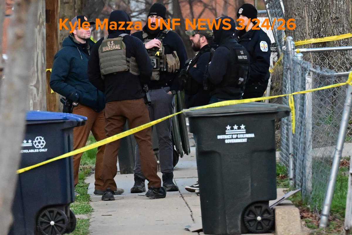 Metropolitan Police Department officers, U.S. Marshals and agents with the Bureau of Alcohol, Tobacco, Firearms and Explosives (ATF) execute a search warrant at the scene where overnight a U.S. Park Police officer was shot in Southeast, Washington, D.C. on March 24, 2026. The officer was shot while inside an unmarked vehicle on the 5000 block of Queens Stroll Place SE